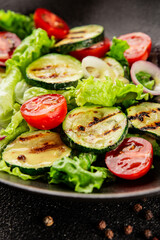 Salad grilled zucchini, tomato, lettuce tasty snack fresh delicious gourmet food background on the table rustic food top view copy space keto and paleo diet vegan and vegetarian food