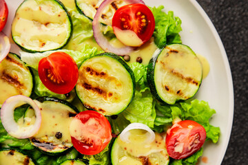 Salad grilled zucchini, tomato, lettuce tasty snack fresh delicious gourmet food background on the table rustic food top view copy space keto and paleo diet vegan and vegetarian food