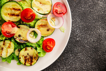 Salad grilled zucchini, tomato, lettuce tasty snack fresh delicious gourmet food background on the table rustic food top view copy space keto and paleo diet vegan and vegetarian food