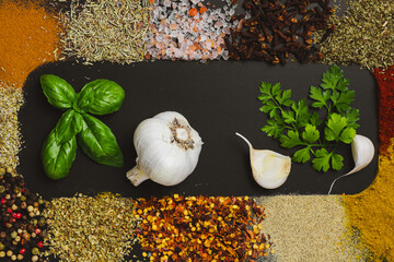 Frame made with different spices on dark background, flat lay. Space for text