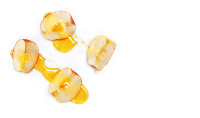 Honey drizzled apple slices on a white background with space for text. Top view, flat lay