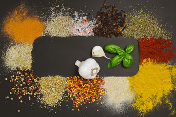 Frame made with different spices on dark background, flat lay. Space for text