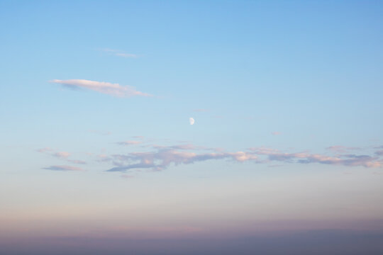 Peaceful Twilight Sky with Crescent Moon and Soft Clouds