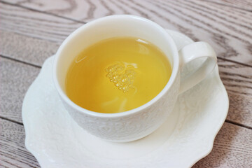 Herbal linden tea in a mug on a wooden table
