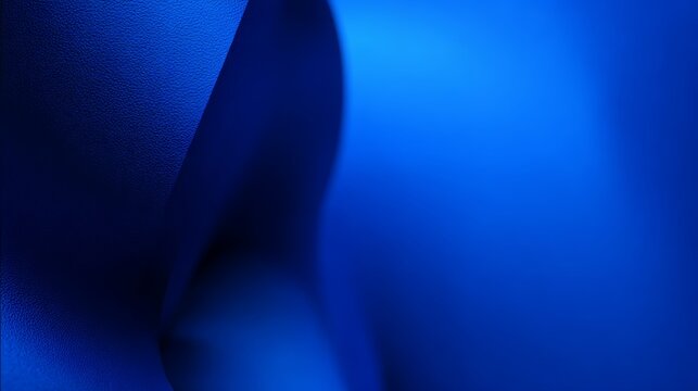 Exploring a smooth gradient of ultramarine color, this composition highlights a minimalist design featuring deep vivid blue tones and subtle curves, creating a tranquil atmosphere.