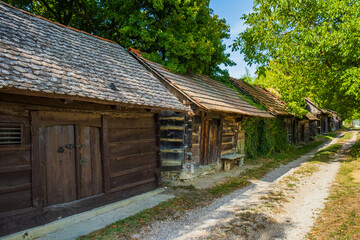 Naklejka premium Historic wooden cottages street in Stare Obreske kleti, Kalnik, Prigorje region of Croatia 