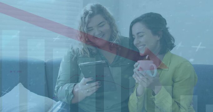 Animation of arrow on falling bar graph over diverse lesbian couple watching video in digital tablet