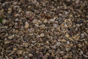 A detailed view of assorted gravel stones in various earthy tones, commonly used for landscaping, construction, or pathways.