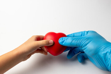 Child and Gloved Hand Holding Heart