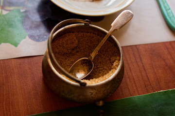 Antique Brass Sugar Bowl with Spoon on Rustic Wooden Table Setting