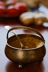 Rustic Metal Spice Bowl with Spoon on Wooden Table