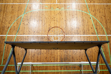 top view of the basketball hoop and the lighted gym floor indoor © Dmitry