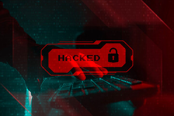 Cyber Attack system hacked concept. Hacker hands typing on a keyboard with a glowing red warning...