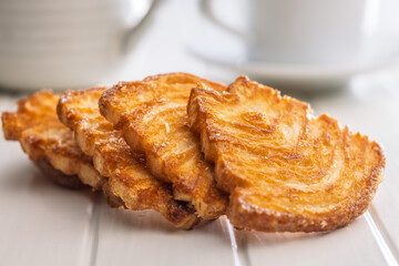 Le sfoglie. Crispy sweet pastry on white table.