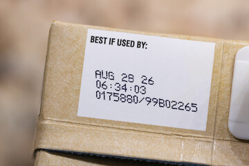 Close up text best before date on carton of broth