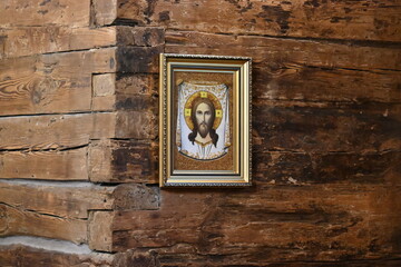 interior of a wooden church in Szczytnicki Park, Wroclaw, with a cross and icons of Mary and Jesus
