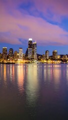 Obraz premium City skyline at twilight reflected on water