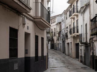 Narrow street ascending in plasencia, spain, showing traditional architecture