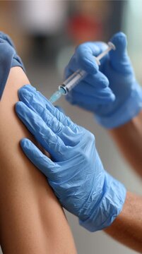 Vaccination injection: A close-up shot of a healthcare worker administering an injection into a person's arm, offering a perspective on medical procedures.