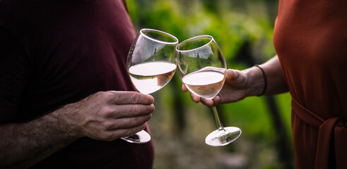 happy couple tasting wine in a vineyard