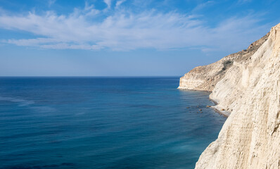 Rocky coastline ocean water. White cliffs and pebble beach. Pissouri Limassol Cyprus