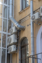 Air conditioners are installed on the facade of the building. device for comfortable living in hot...