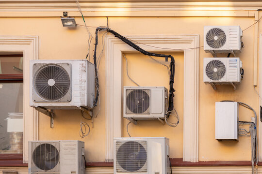 group of air conditioners is mounted on the wall of the building. cooling in hot weather, technologies for adjusting the temperature in the house. climate and weather conditions.