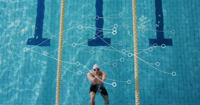 Swimmer pushing off starting block and executing backstroke in competition pool for speed training