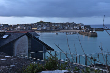 Evening view of St Ives, Cornwall, England after sunset looking over harbour and bay with...