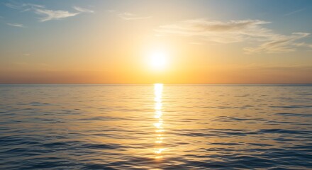 Obraz premium A breathtaking sunset over the vast ocean, casting a golden glow on the water's surface, reflecting the sky's vibrant hues. The scene evokes tranquility and the beauty of nature
