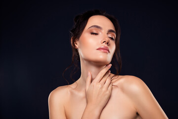 Fototapeta premium Portrait of a young woman with flawless glowing skin showcasing a natural beauty look, soft makeup