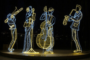Giant luminous Christmas glowing figure of musicians