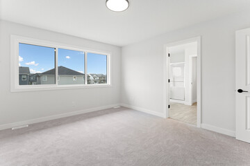 Large, empty room with a window and a door