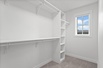 White closet with a window and shelves