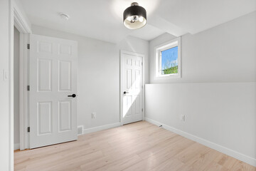 White room with a window and a door