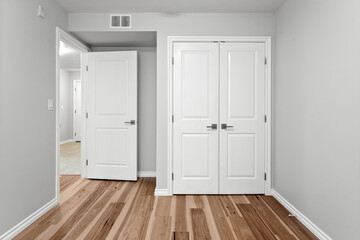 White room with two doors and a window