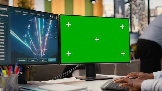 Engineer looks at power lines analytics dashboard on isolated screen PC showing metrics. African american woman uses mockup computer in office used to analyze transmission tower sensor data, camera B