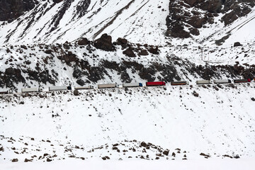 Heavy traffic at Los Libertadores Pass, with trucks queued in the snow covered Andes, connecting...