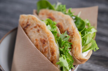 Flatbread with greens served in a cafe. 