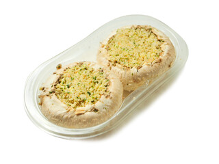Two stuffed mushrooms in a plastic package on white background. Fine meal made of natural ingredients. Agriculture and farming, Food industry