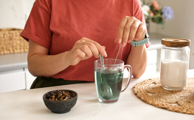 Woman Making Blue Matcha Tea In Home Kitchen, Close-Up