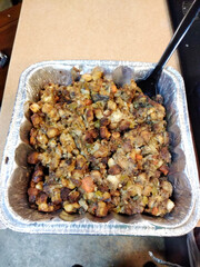 Stuffing in a foil pan with serving spoon
