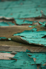Close up on cracked turquoise paint on wooded surface