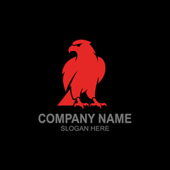 Fototapeta premium A stylized red eagle logo featuring a fierce bird of prey against a black background.
