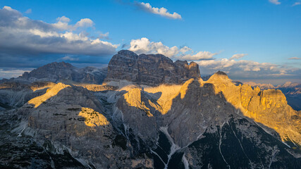 Obraz premium Dramatic sunset shadows over the rugged Marmolada massif the highest peak of the Dolomites Italy with glowing cliffs and alpine valleys