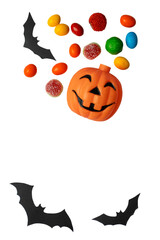 Halloween pumpkin with smiling face surrounded by colorful candies and black bats isolated on...