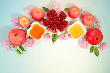 Autumn banner with honey, apples, pomegranates, flowers, dried fruits for holiday greetings, composition for Jewish holiday Rosh Hashanah with traditional symbols, creative layout for design, template