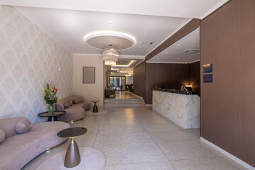 Luxurious interior of a hotel lobby with a polished marble front desk