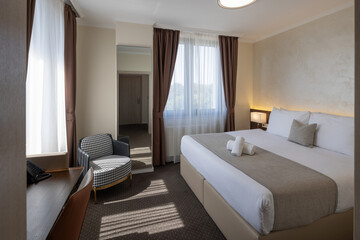 Interior of a hotel room with a master bed in the morning