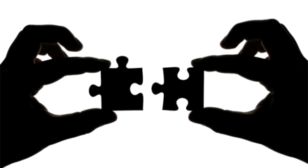 Silhouette hands holding puzzle pieces, preparing to connect them, teamwork concept.